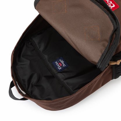 Top-down view of Coors Banquet x Seager backpack showing spacious black-lined interior