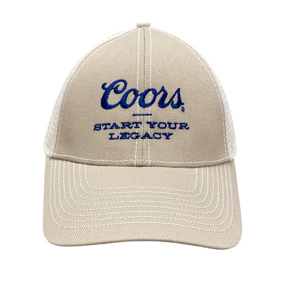 Front view of the Coors Banquet Legacy Cap featuring beige fabric, white mesh sides, and blue embroidered text reading 'Coors – Start Your Legacy'.