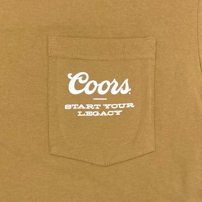 Close-up of brown Coors Banquet t-shirt pocket with white printed text reading 'Coors – Start Your Legacy'